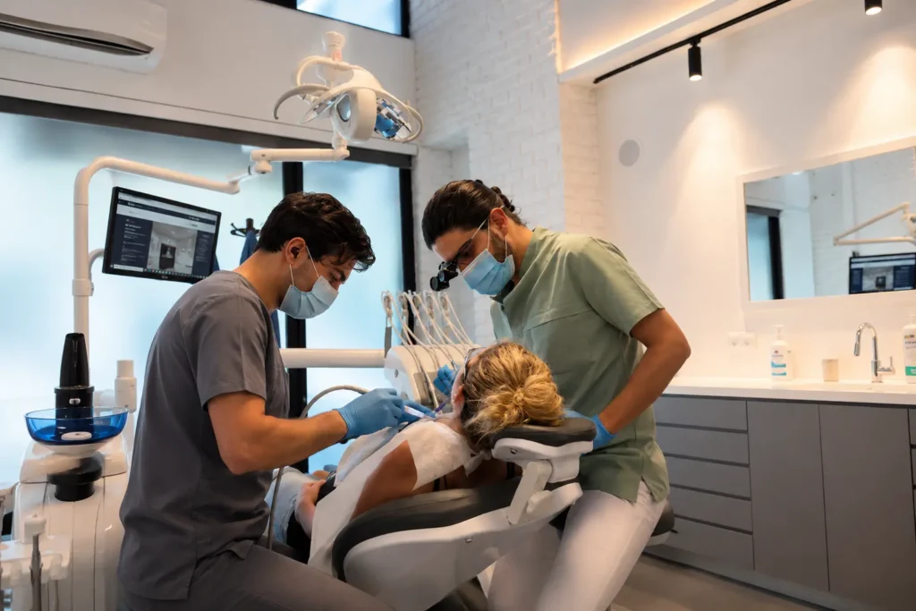 Dentists treating a patient in Istanbul, illustrating care discussed in this dental treatment cost Turkey vs UK guide